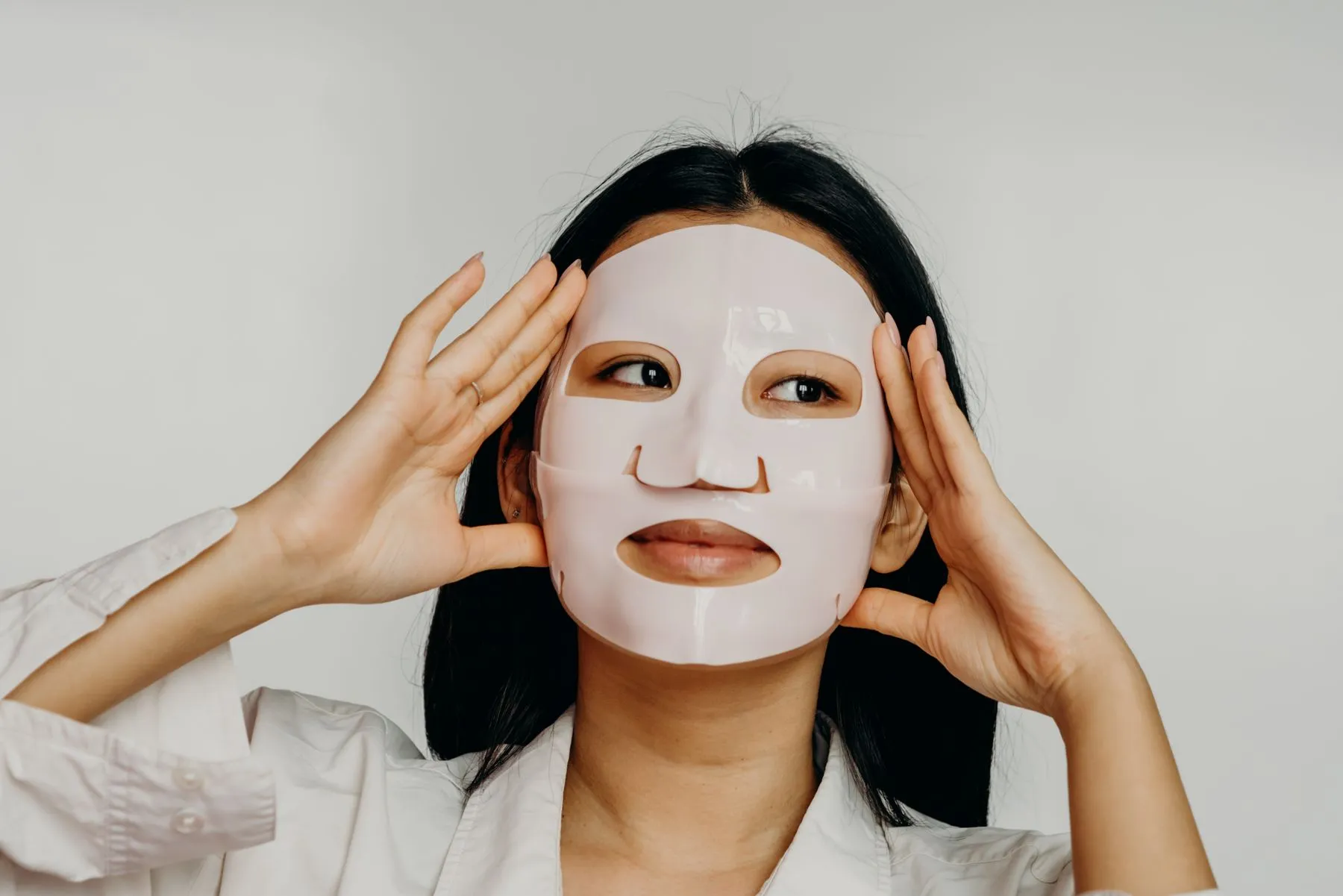 Woman relaxing with a hydrating Korean sheet mask